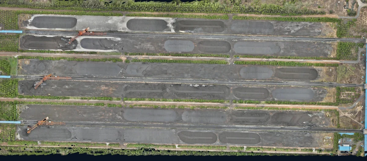 Overhead view of a full stockyard with multiple piles, access lanes and empty areas