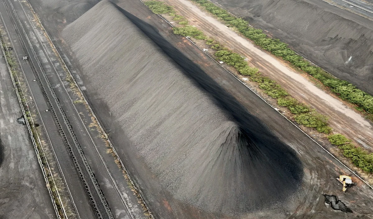 A long stockpile with its surrounding apron visible from above